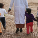 A woman walks with orphans at the Agoheld orphanage, hospital, training center and school on March 19, 2013, in Addis Ababa, Ethiopia. (Sean Gallup/Getty Images)